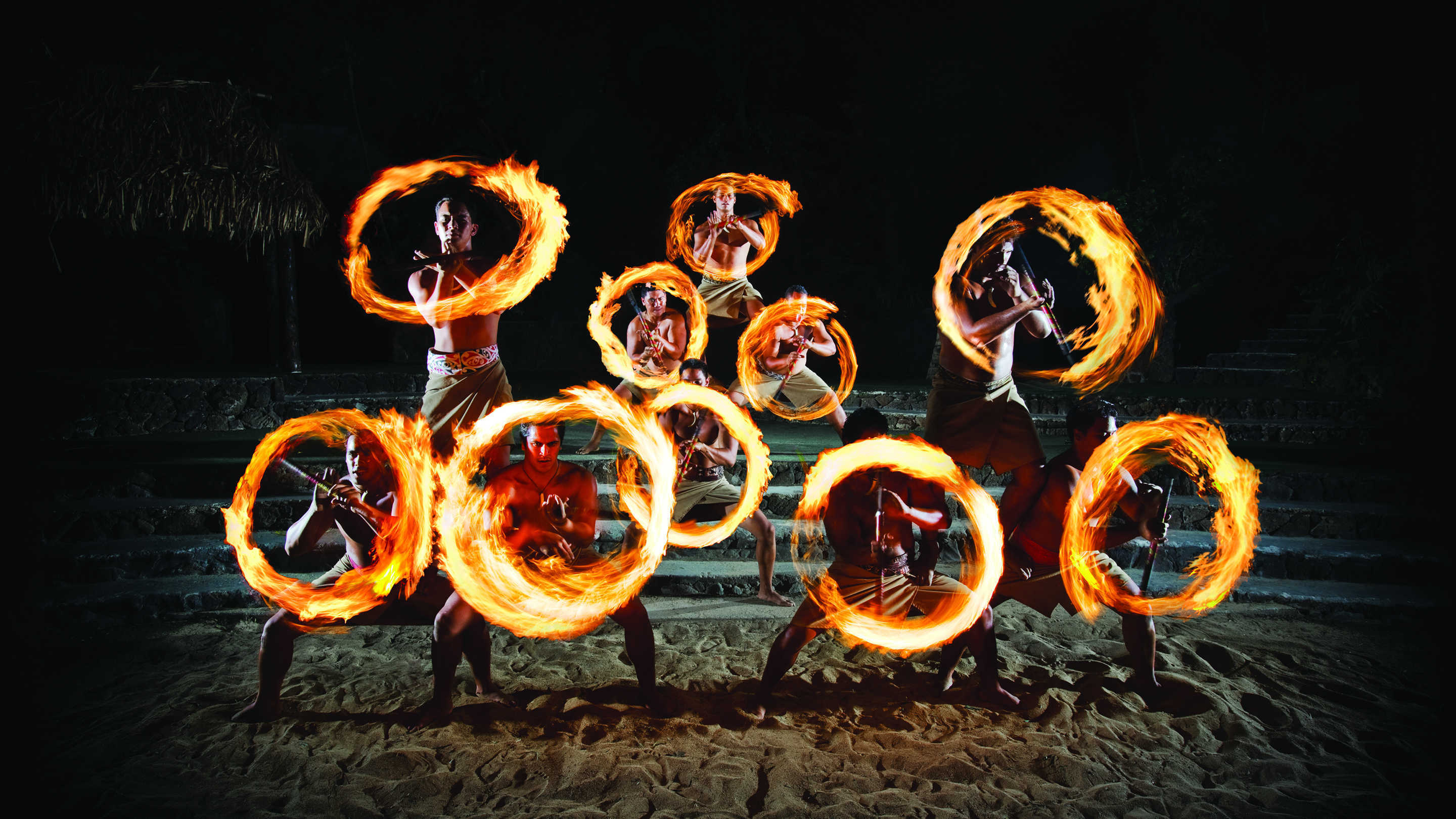 Fire knife dancers spinning their knives